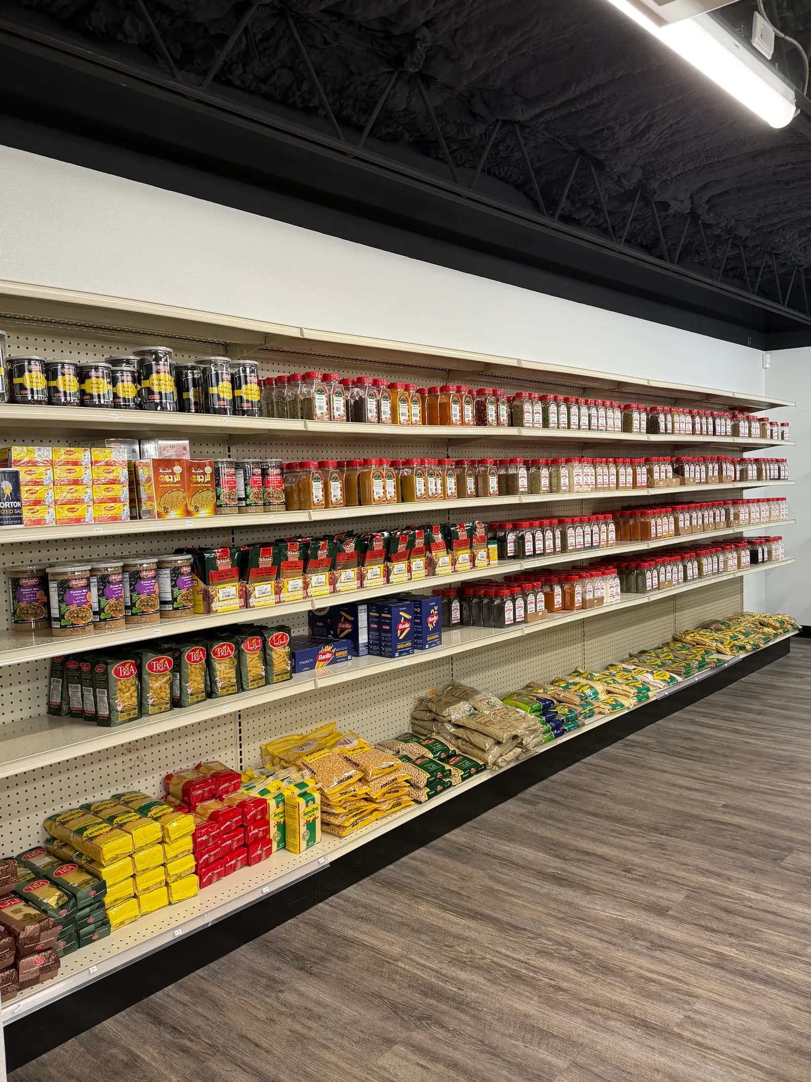 Shelves of spices, rice, and pasta inside Middle Beast Market